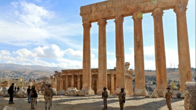 Lebanese Army soldiers stand guard before the six iconic columns of the Temple of Jupiter.