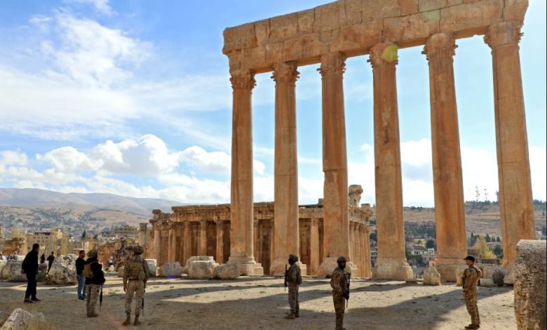 Lebanese Army soldiers stand guard before the six iconic columns of the Temple of Jupiter.