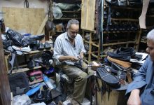 Hany, a master cobbler, meticulously repairs footwear within the vibrant arteries of Luxor’s Market Street. Photo: Abul-Hassan Abdulsattar