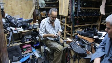 Hany, a master cobbler, meticulously repairs footwear within the vibrant arteries of Luxor’s Market Street. Photo: Abul-Hassan Abdulsattar