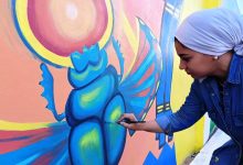 Dr.Yara El-Beheiry paints upon the mural. Photo: Wafaa Amin